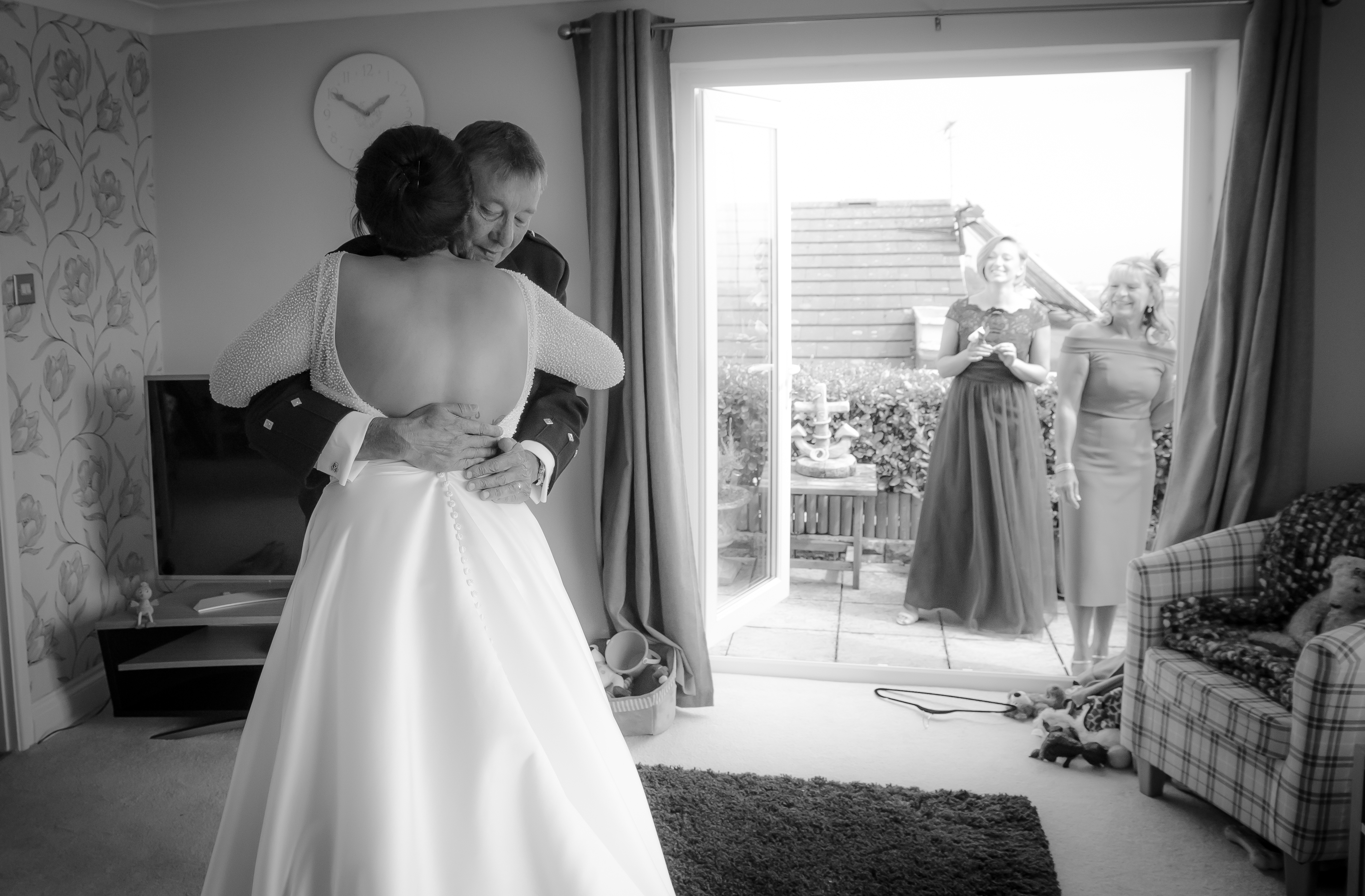 Bride and father hug before wedding